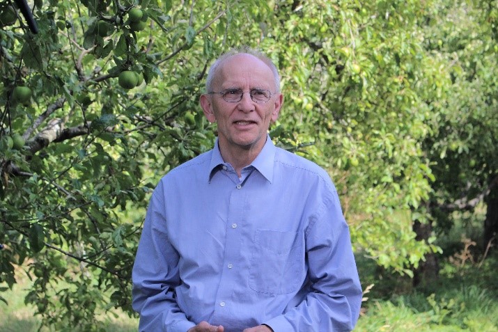 Armin Werner, Lincoln Agritech Group Manager of Precision Agriculture, medium shot from waist up standing in an apple orchard.