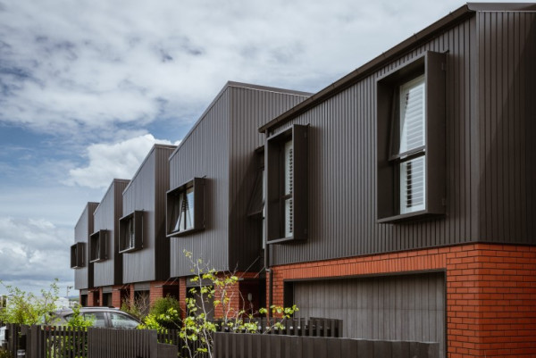 Street view of a row of multi-unit houses showing how close they are to each other