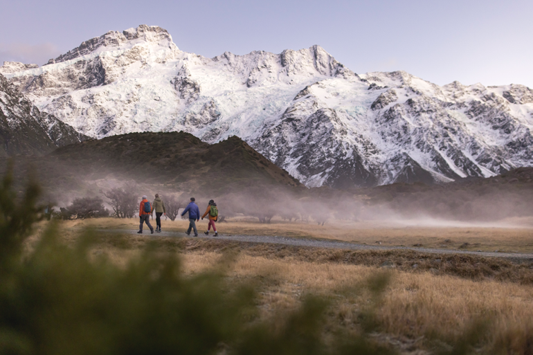 Photograph of four people walking the Hooker Valley Track in Mount Cook National Park.